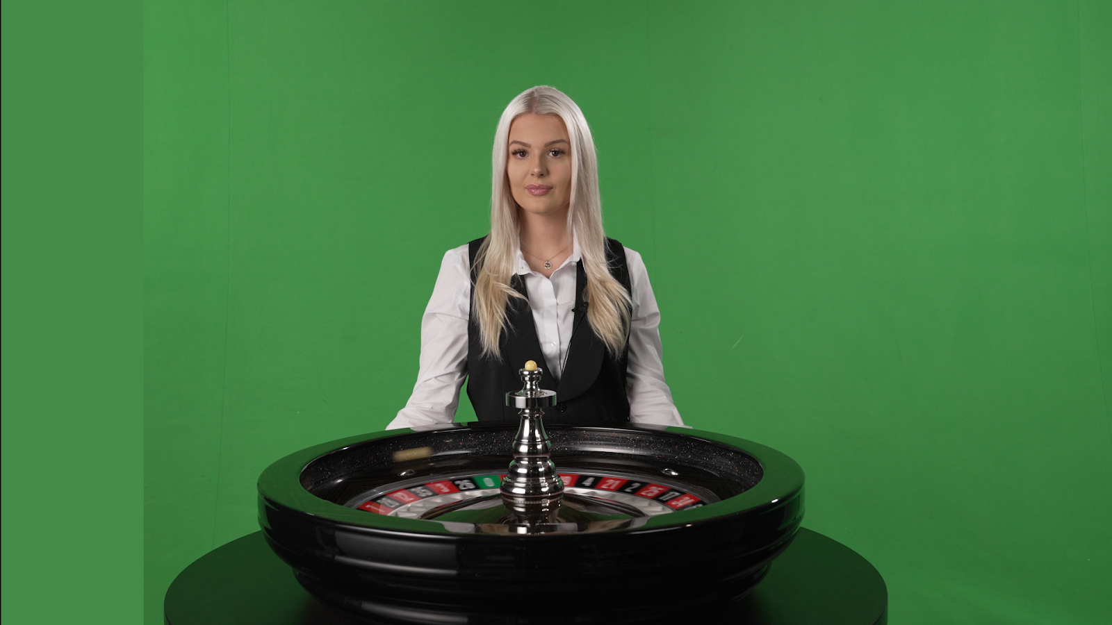 Source frame — dark table and wheel with green-screen reflections